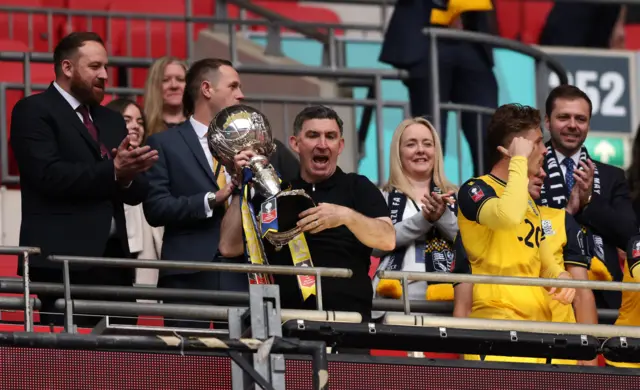 Kevin Maher holds up the FA Trophy