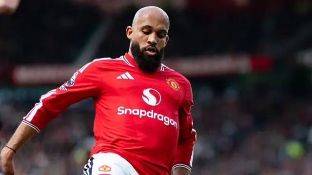 Mbeumo in a red Manchester United shirt with white and yellow details