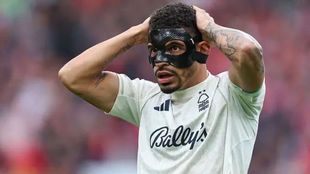 Gibbs-White holds his hand above his head in disappointment.