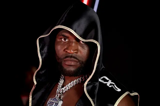 Francis Ngannou in a black hood and big chain