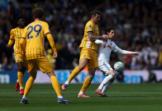 Brenden Aaronson of Leeds United is challenged by Lewis Dunk of Brighton & Hove Albion during the Premier League match between Leeds United and Brighton & Hove Albion