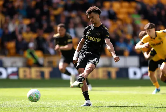 Antonee Robinson of Fulham scores his team's first goal from the penalty spot during the Premier League match between Wolverhampton Wanderers and Fulham at Molineux