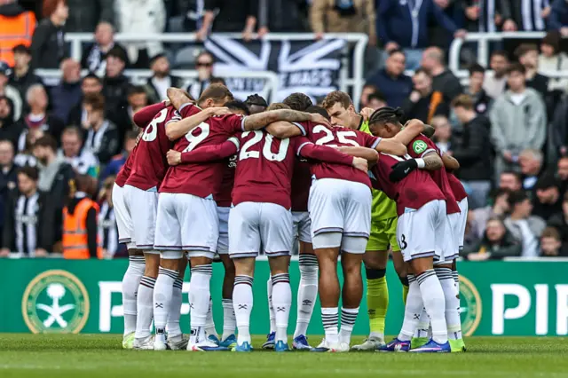 West Ham players gather in a team huddle during the Premier League match between Newcastle United and West Ham United at St. James's Park in Newcastle, United Kingdom