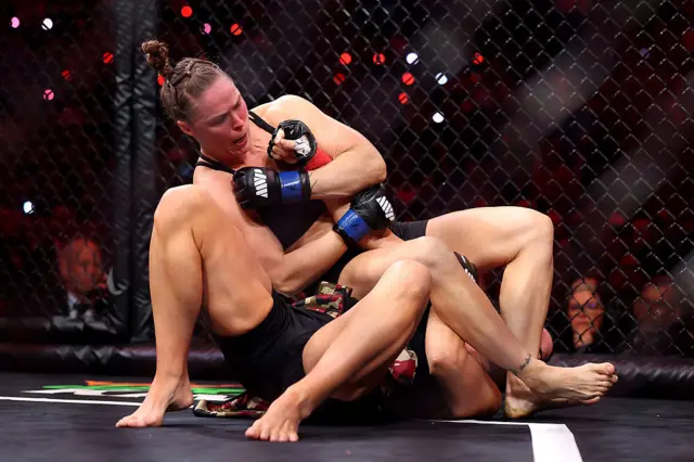 Ronda Rousey uses an armbar on Gina Carano