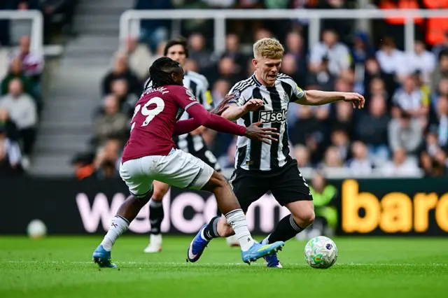 Lewis Hall of Newcastle United (3) goes down under a challenge during the Premier League match between Newcastle United and West Ham United at St James' Par
