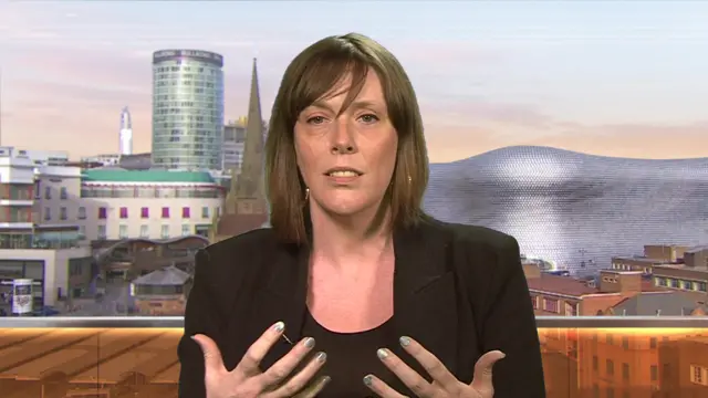 Former minister Jess Phillips in a black blazer and tank top gesturing with both her hands as she answers questions