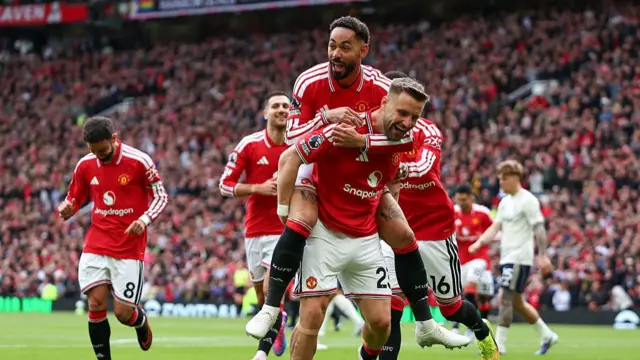 Luke Shaw celebrates with team mates after scoring a goal