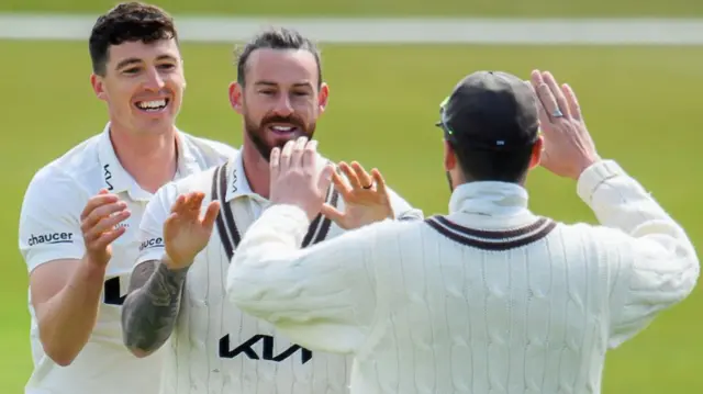 Surrey's Jordan Clark celebrating with his team-mates after taking a catch to dismiss Jonny Bairstow of Yorkshire in the County Championship.