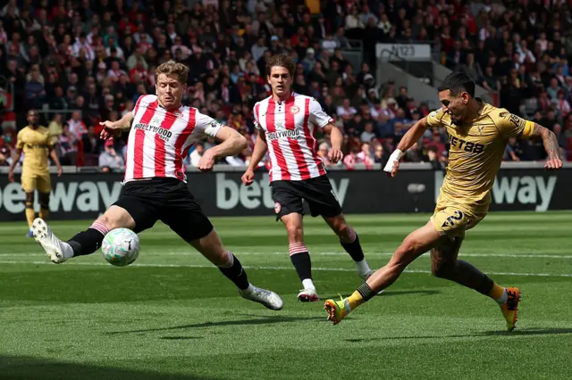 Crystal Palace's Colombian defender #02 Daniel Munoz (R) shoots at goal past Brentford's Norwegian defender #20 Kristoffer Ajer during the English Premier League football match between Brentford and Crystal Palace at the Gtech Community Stadium in London