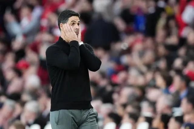 Arteta puts his hands to his face after Arsenal hit the post