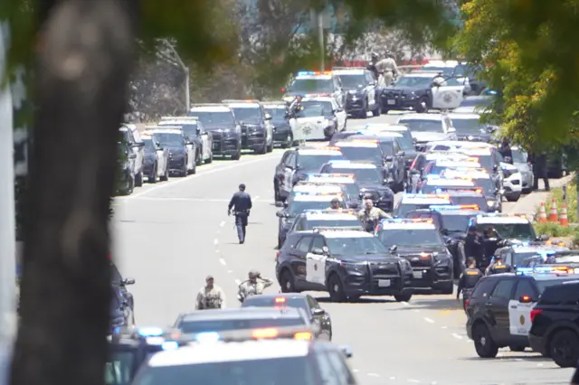Police vehicles are seen in the area.