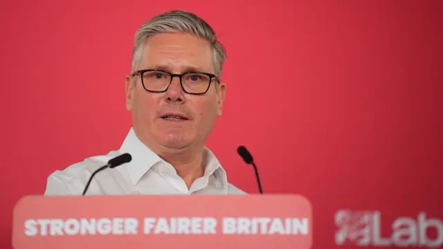 Keir Starmer in front of red podium
