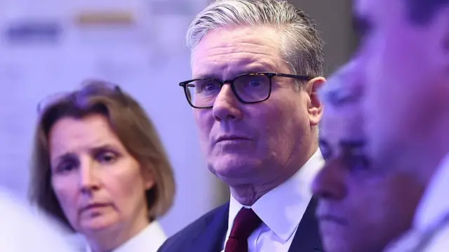 Britain's Prime Minister Keir Starmer (C), flanked by Mayor of London Sadiq Khan (2R) and Police Commander Clair Haynes (L), listens as he meets with Metropolitan police officers to discuss operational planning ahead of this weekend's planned protests, in the Lambeth area of London on May 15, 2026