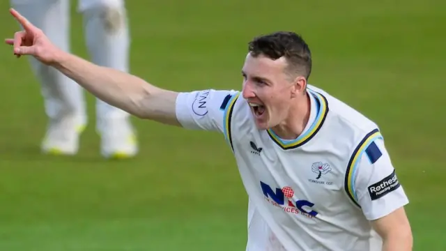 Harry Brook pointing with his right index finger raised while celebrating taking a wicket for Yorkshire against Surrey