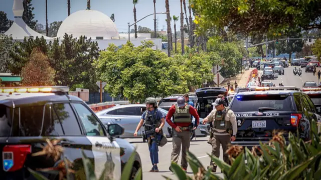 Heavily armoured police at the scene, with the mosque's dome in the background
