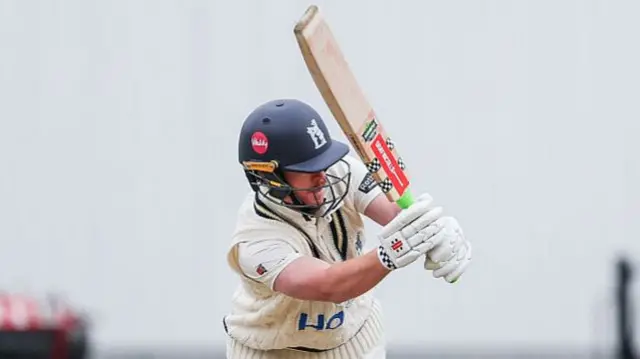 Alex Davies bats and plays a shot for Warwickshire