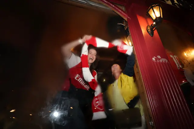 Fans of Arsenal celebrate as Arsenal are confirmed