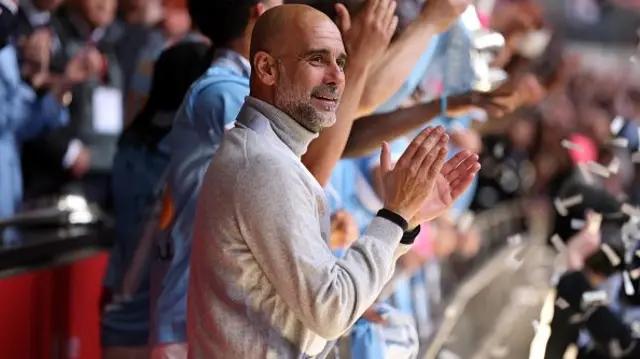 Pep Guardiola looks on