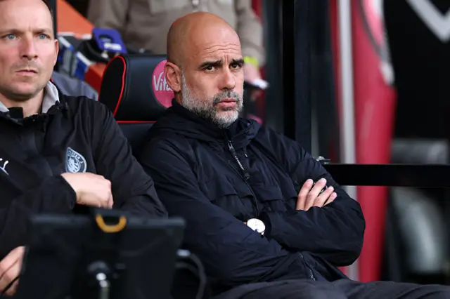 Pep Guardiola, Manager of Manchester City, looks on