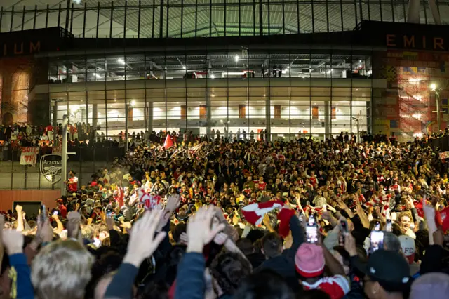 Arsenal fans celebrate their team wining the English Premier League, outside the Emirates Stadium