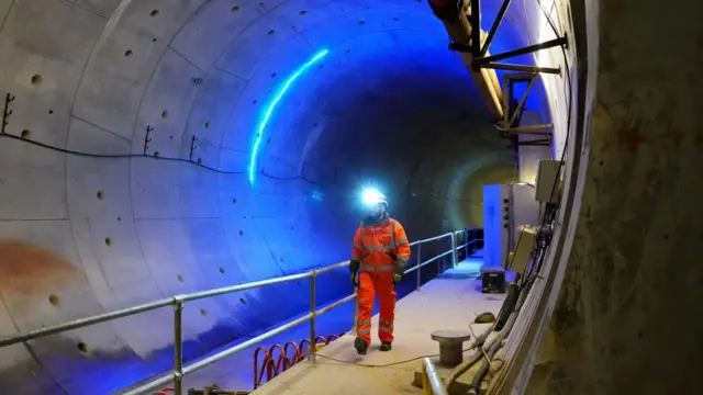 A member of HS2 staff walking through Chilterns tunnel close to its ventilation shaft