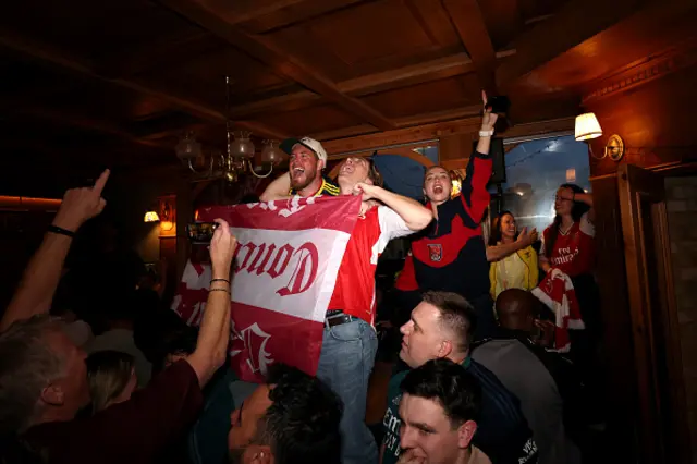 Fans of Arsenal celebrate as Arsenal are confirmed as Premier League champions