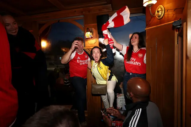 Fans of Arsenal celebrate as Arsenal are confirmed as Premier League champions