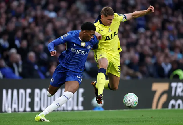 Josh Acheampong of Chelsea and Micky van de Ven of Tottenham Hotspur compete for the ball