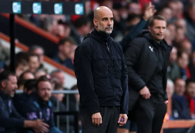 Pep Guardiola, Manager of Manchester City, looks on