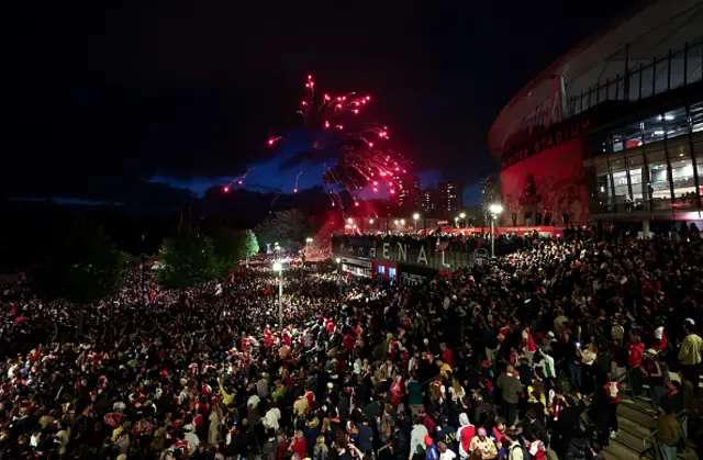 Arsenal fans celebrate outside the Emirates