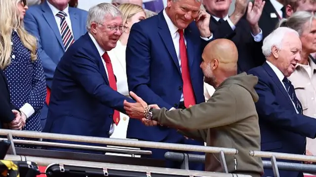 Manchester City manager Josep Guardiola shakes hands with ex-Manchester United manager Sir Alex Ferguson