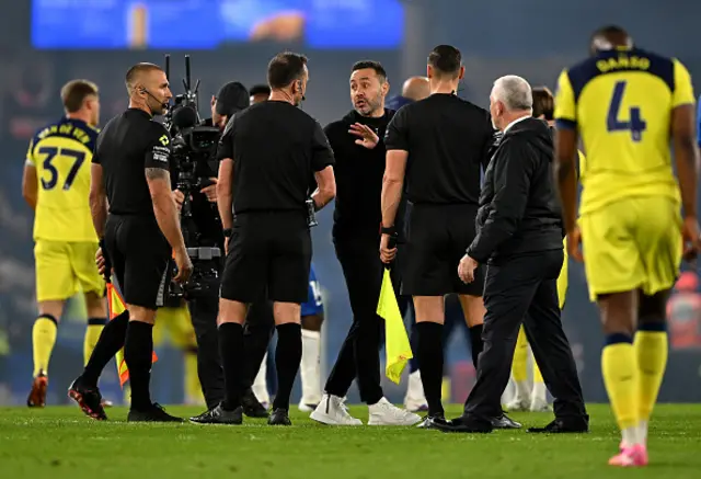 Roberto De Zerbi, Manager of Tottenham Hotspur, interacts with Referee Stuart Attwell