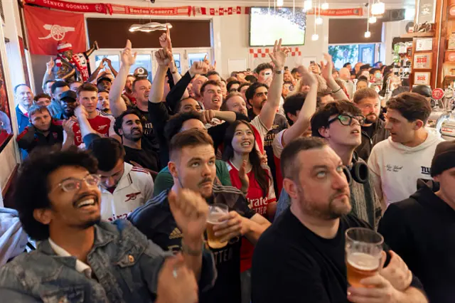 Arsenal fans watch as Bournemouth play Manchester City, from inside the Tollington Arms pub