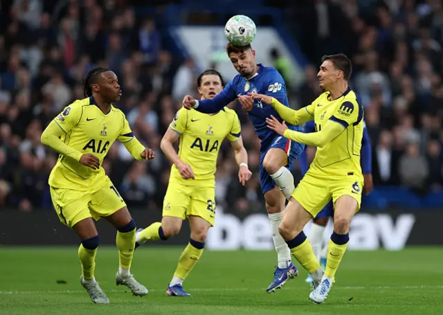 Pedro Neto of Chelsea headers the ball while under pressure from Joao Palhinha