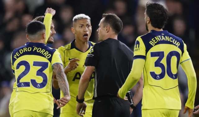 Tottenham Hotspur's Richarlison, James Maddison, Pedro Porro, and Rodrigo Bentancur remonstrate with referee Stuart Attwell