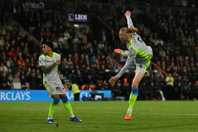 Erling Haaland watches on as he scores t