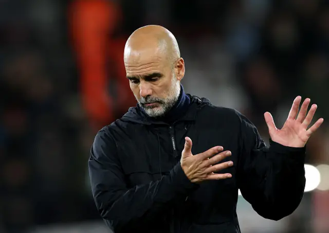 Pep Guardiola, Manager of Manchester City, acknowledges the fans