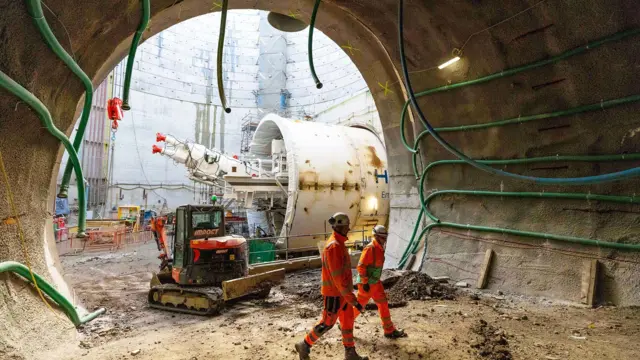 Engineers walking in a tunnel near a building site