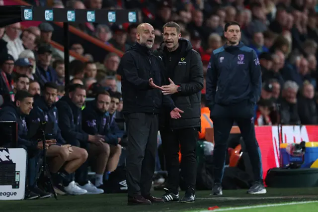 Pep Guardiola, Manager of Manchester City, interacts with Fourth Official Craig Pawson
