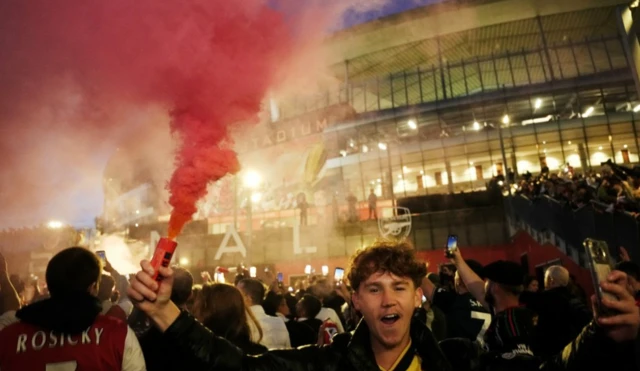 Arsenal fans celebrate outside the Emirates
