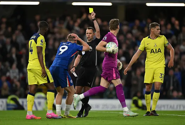 Liam Delap of Chelsea is shown a yellow card by Referee Stuart Attwell