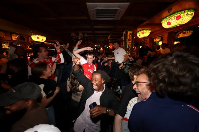 Fans of Arsenal celebrate as Arsenal are confirmed as Premier League champions