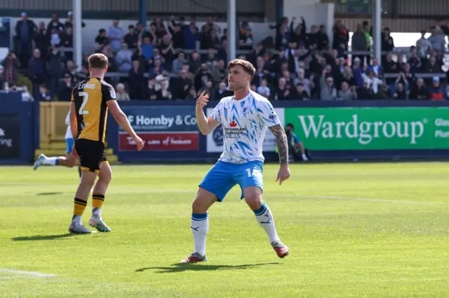 Charlie McCann celebrates scoring for Barrow against Newport