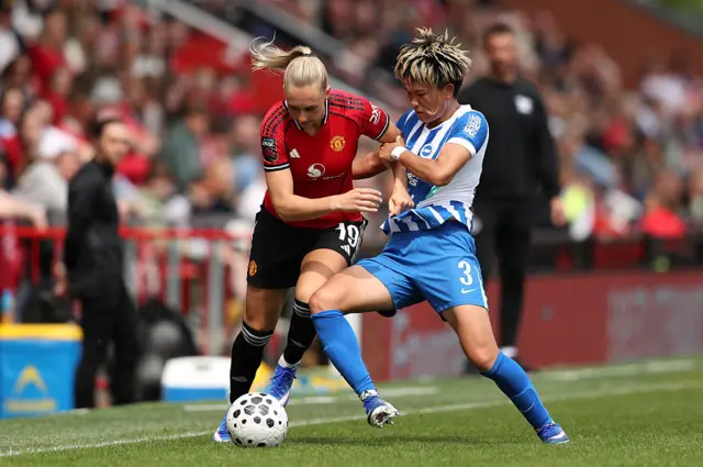Ellen Wangerheim of Manchester United is challenged by Moeka Minami of Brighton & Hove Albion during the Barclays Women's Super League match between Manchester United and Brighton & Hove Albion at Progress with Unity Stadium on May 02, 2026.
