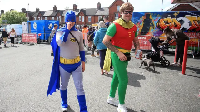 Cambridge United fans wearing Batman and Robin fancy dress costumes arrive at the Mornflake stadium in Crewe