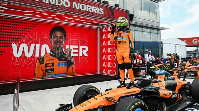 Lando Norris stood on his car after his sprint race win in Miami