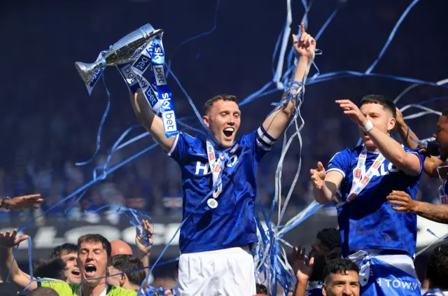 Ipswich Town's Dara O'Shea celebrates with the trophy on the pitch after Ipswich Town secured promotion from the Championship