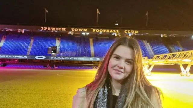 Imogen Cook stood by the pitch at Ipswich Town's Portman Road ground