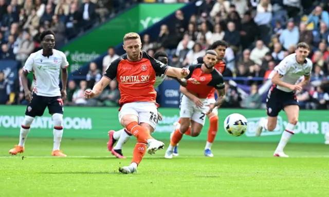 Jordan Clark scores a penalty for Luton at Bolton