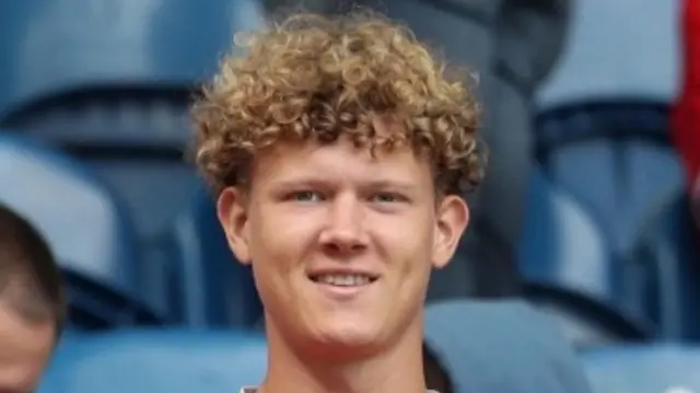 A picture of William Ascough with curly blond hair wearing a red Middlesbrough shirt